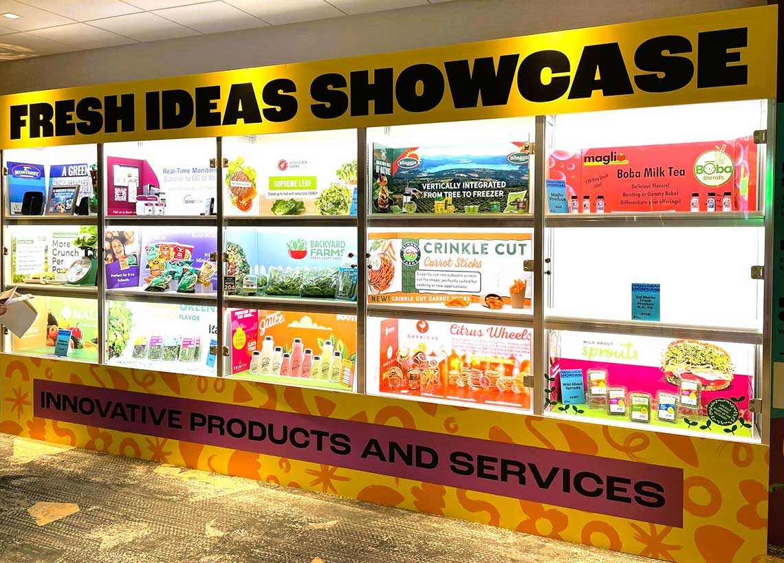 Exhibition display titled "Fresh Ideas Showcase" with various product promotions and samples.