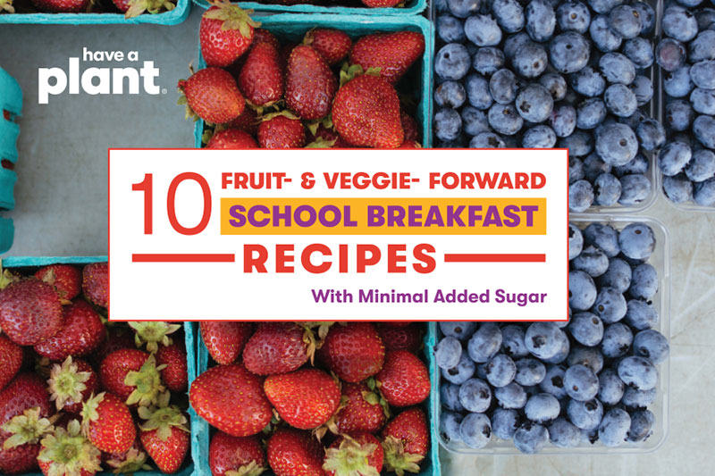 Fresh strawberries and blueberries with a text overlay promoting school breakfast recipes.