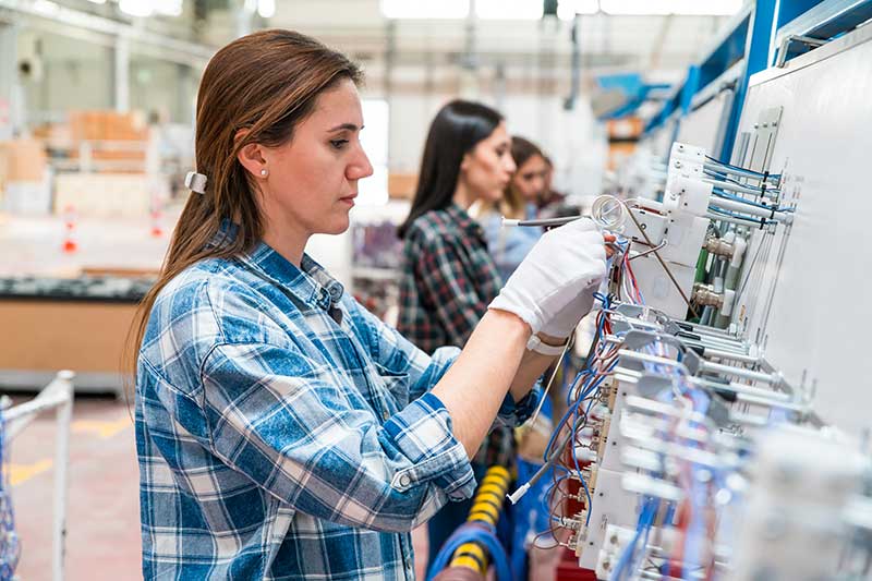 Female manual workers team working on the production line in factory